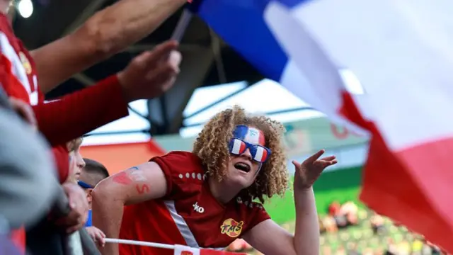 A fan of France shows their support