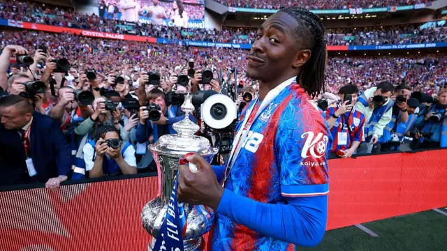 Eberechi Eze of Crystal Palace celebrates with the FA Cup trophy after his team's victory in the Emirates FA Cup Final match between Crystal Palace and Manchester City at Wembley Stadium
