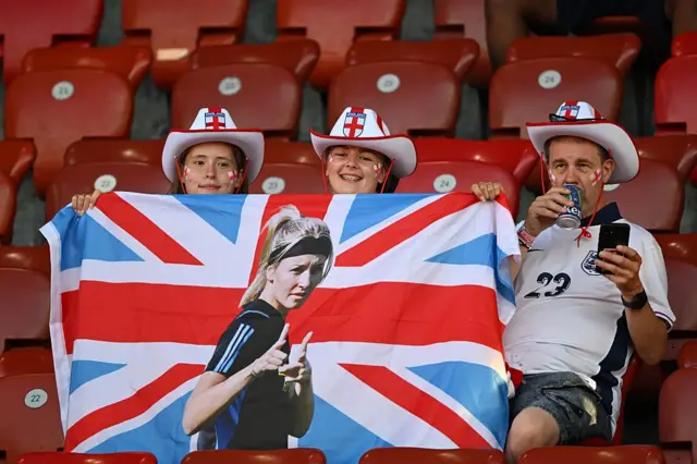 Fans in crowd holding Leah Williamson banner
