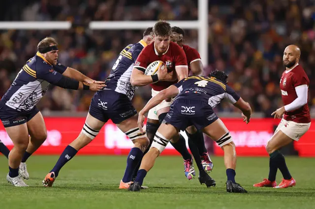 Joe McCarthy of British & Irish Lions is tackled by Lachlan Shaw and Cadeyrn Neville