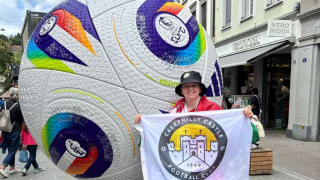 Bethan Bushen in St Gallen by a giant promotional Euros 2025 football