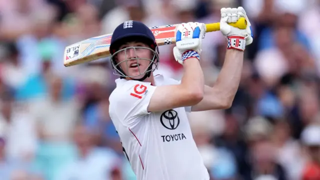 Harry Brook looks up in the air after a ball he's just hit v India.