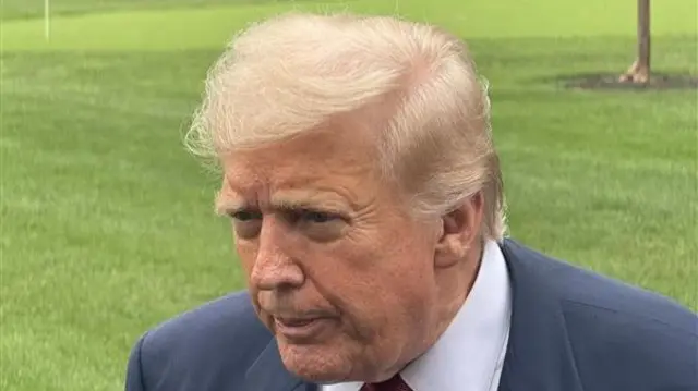 Donald Trump speaks to reporters outside the White House