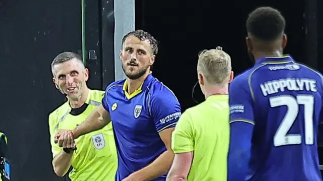 Joe Lewis after colliding with the assistant referee