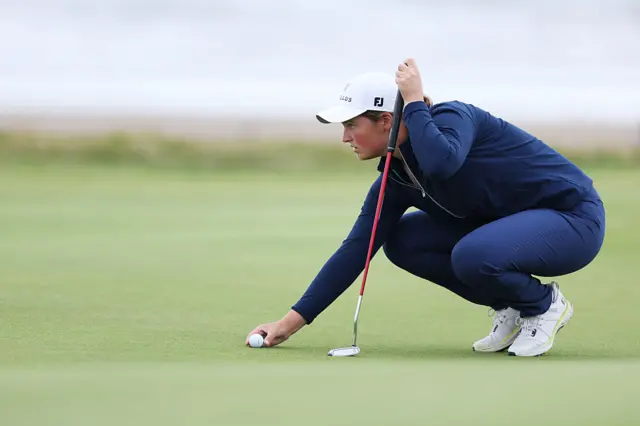 Lottie Woad places her ball down on a green