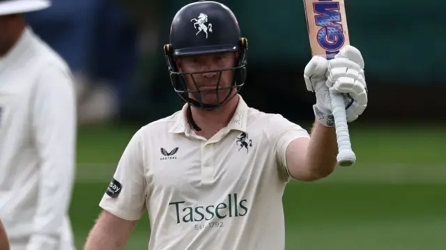 Ben Compton raises his bat