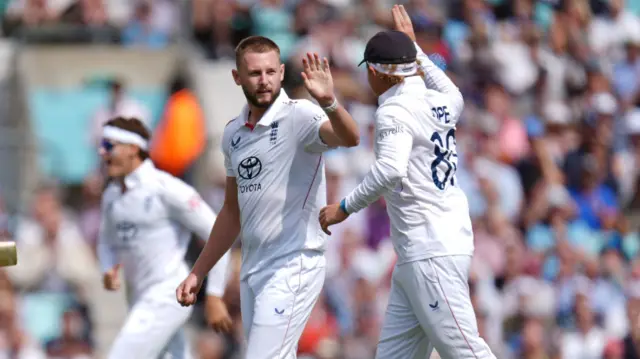 Gus Atkinson celebrates with Ollie Pope after taking a wicket v India.