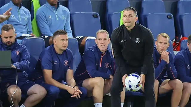 Luton boss Matt Bloomfield holds a football