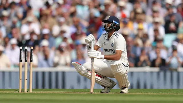 Washington Sundar squats looking frustrated after being dismissed vs England.