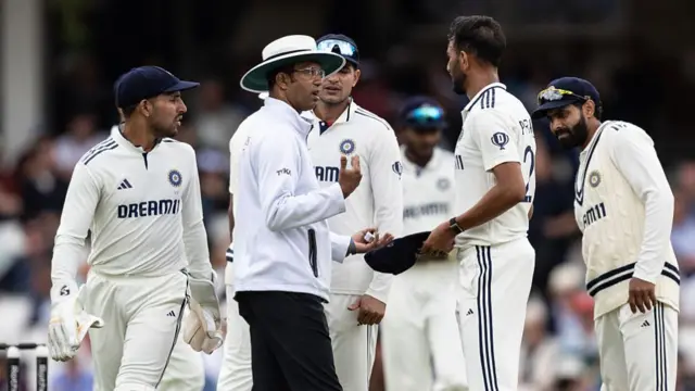 The umpire talks to Prasidh Krishna at The Oval.