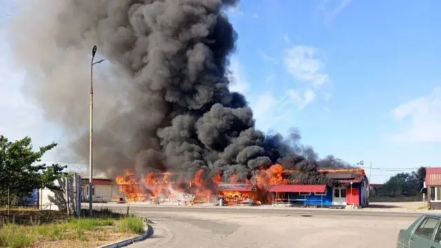 Smoke rises from a shop front in the southern Kherson region.