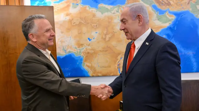 Prime Minister Benjamin Netanyahu shakes hands in his office with the US president's special envoy for the Middle Eas