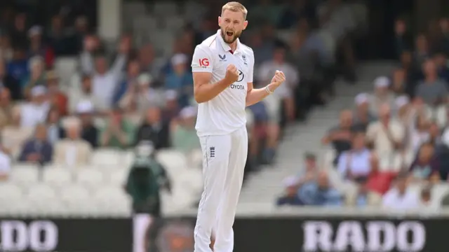Gus Atkinson celebrates taking a wicket vs India.