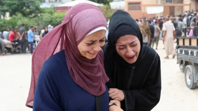Mourners react during the funeral of Palestinians, who were killed by Israeli fire while trying to receive aid on Thursday, and who were killed in overnight Israeli airstrikes on tents, according to medics, at Nasser Hospital in Khan Younis, southern Gaza Strip, August 1, 2025.