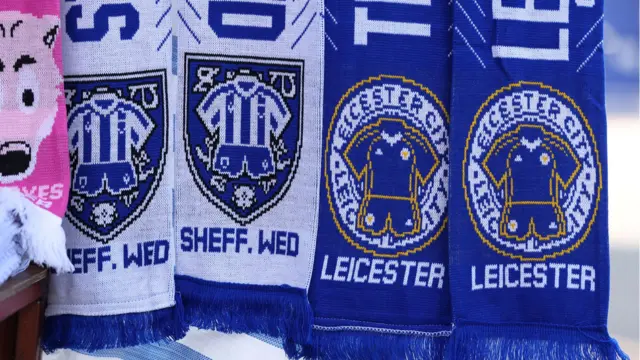 A row of half-nad-half scarves with Sheffield Wednesday and Leicester City colours on