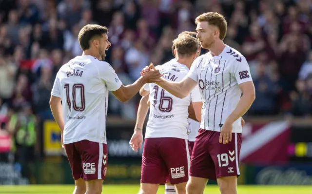 Hearts' Stuart Findlay (R) celebrates with Claudio Braga (L) after scoring to make it 2-2