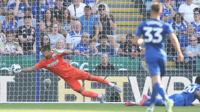 Pierce Charles dives to his right to make a save for Sheffield Wednesday against Leicester City