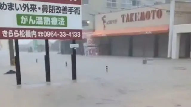 Screengrab of video footage shows debris flowing through flood in south-western Japan