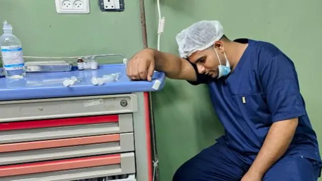 An hospital orderly rests on a chair at the end of a surgical operating theatre at Nasser Medical Complex in Khan Yunis in the southern Gaza Strip