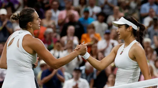 Aryna Sabalenka and Emma Raducanu shake hands at Wimbledon