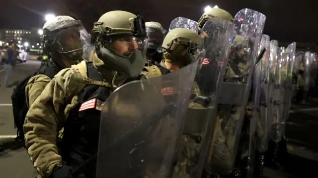 National Guard members hold shields and batons in Washington DC