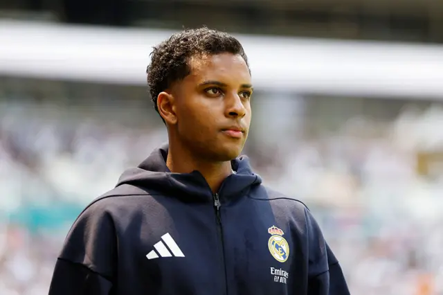 Rodrygo looking on with headphones on