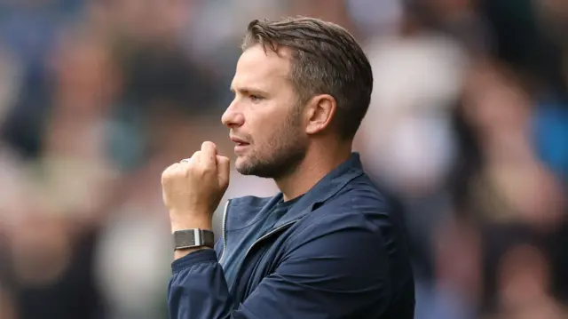 Tom Cleverley looks anxious in the dugout