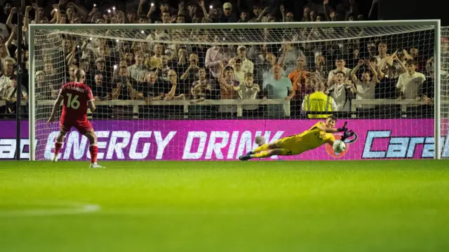 Bromley goalkeeper Sam Long saves a penalty against Ipswich