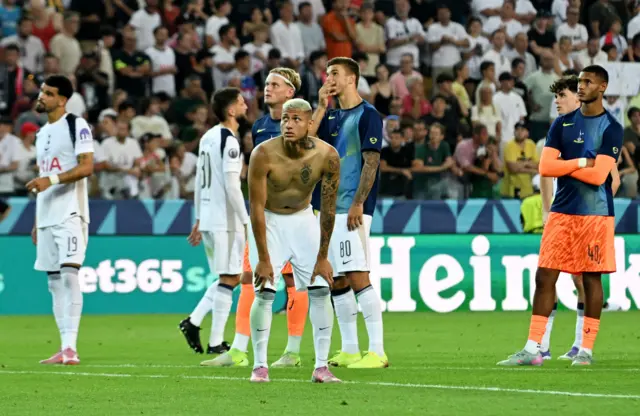 Tottenham players stand dismayed