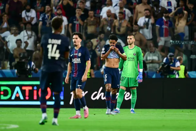 PSG players stand stunned after conceding to Tottenham