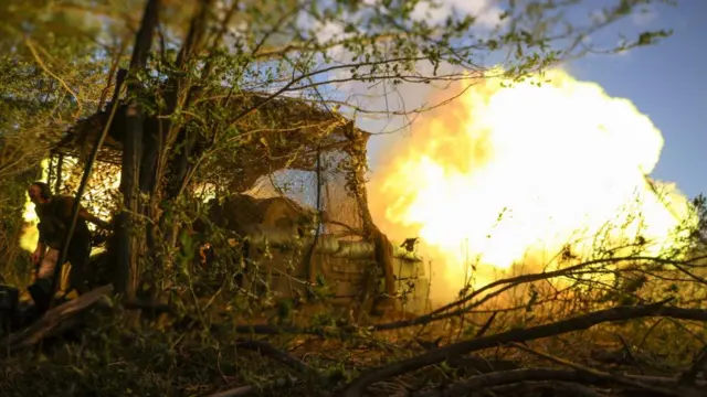 A serviceman of the 82nd Separate Airborne Assault Brigade of the Ukrainian Armed Forces fires a D-30 howitzer towards Russian troops in Donetsk