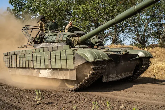 Two Ukrainian soldiers driving a tank in the Kherson region in August 2025