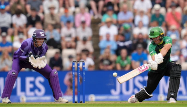 Southern Brave's Laurie Evans batting as Northern Superchargers' Michael Pepper looks on