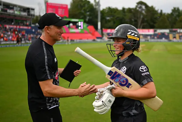 ichael Klinger, Head Coach of Manchester Originals shakes hands with Seren Smale of Manchester Originals following victory