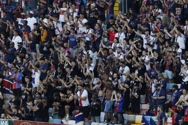 PSG fans chant and sing behind the goal