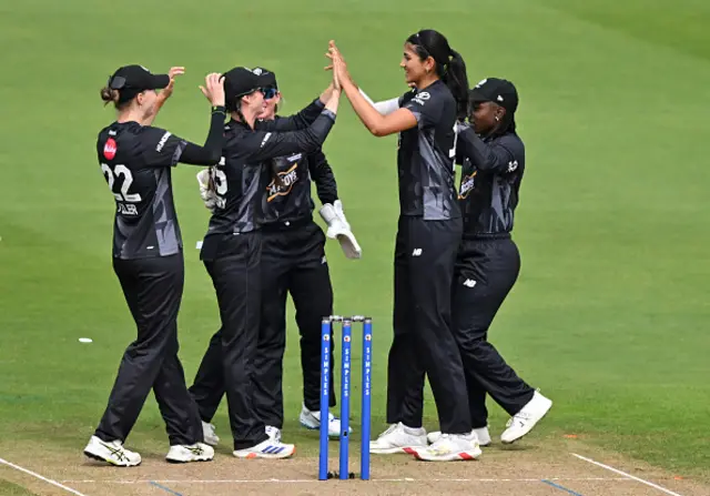 Mahika Gaur of Manchester Originals celebrates with teammates after taking the wicket of Sophia Dunkley of Welsh Fire (not pictured)