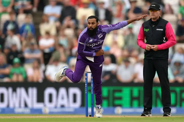 Adil Rashid of Northern Superchargers bowls as Umpire Martin Saggers looks on