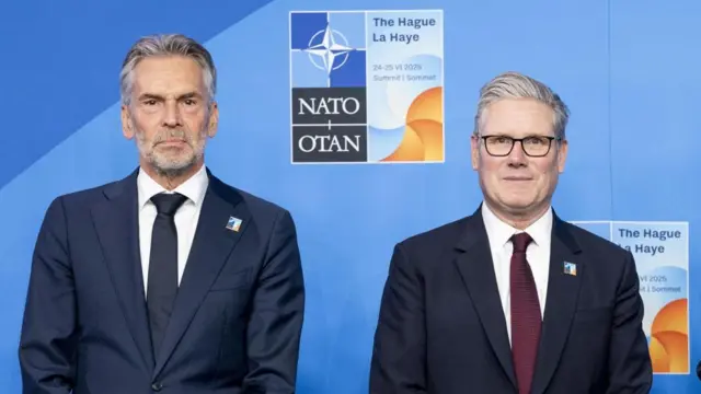 Dick Schoof (left) and Keir Starmer pose for a photo together, there is a Nato logo in the background