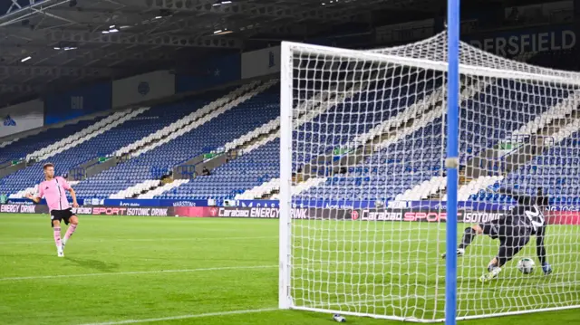 Goalkeeper Lee Nicholls of Huddersfield Town saves Kasey McAteer of Leicester City's penalty to win the game for his side in the penalty shoot out