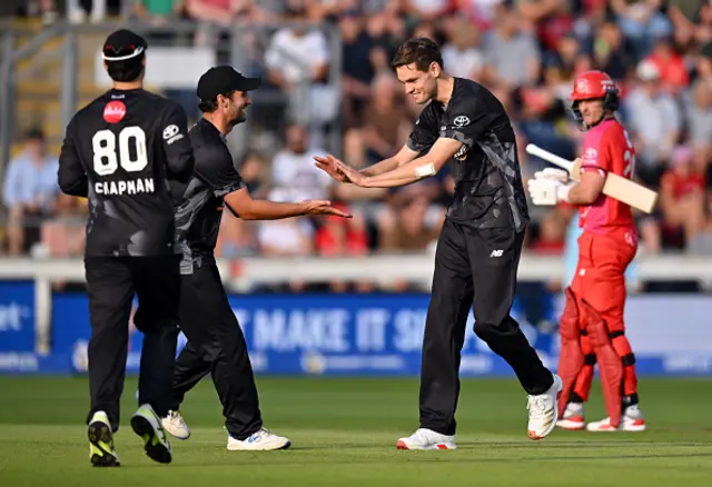 Scott Currie of Manchester Originals celebrates with teammate Lewis Gregory after taking the wicket of Luke Wells