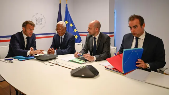 Emmanuel Macron at a table with leaders