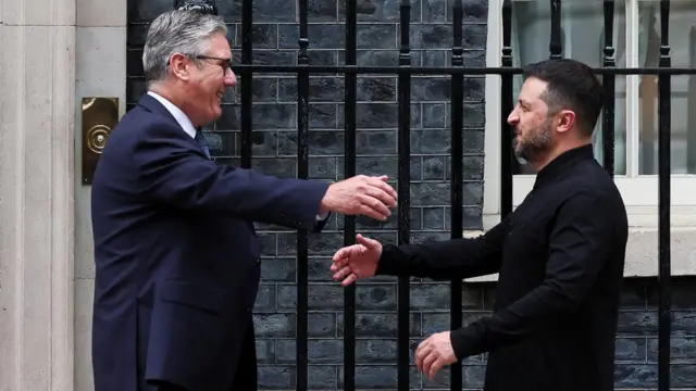 Starmer and Zelensky extend their arms before they hug at Downing Street.