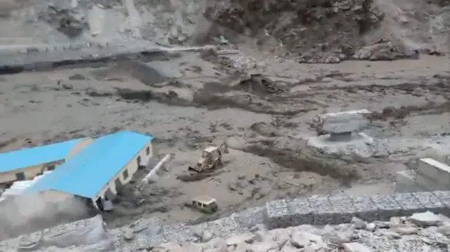 A screengrab from an Indian army video shows the floodwaters rushing through a construction site