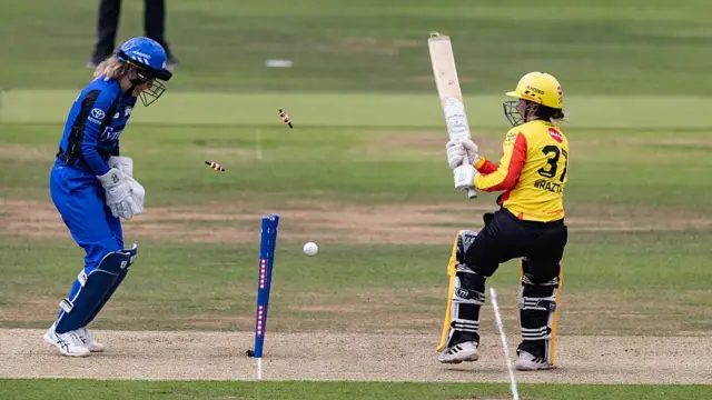 The stumps fly after Nat Wraith is bowled.