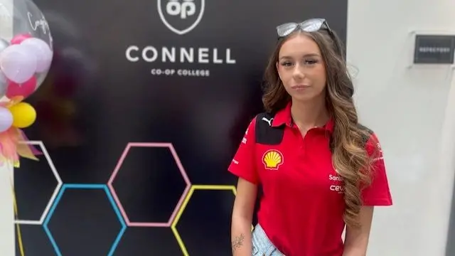 Jessica Pilkington poses for a photo in a red motorsport top