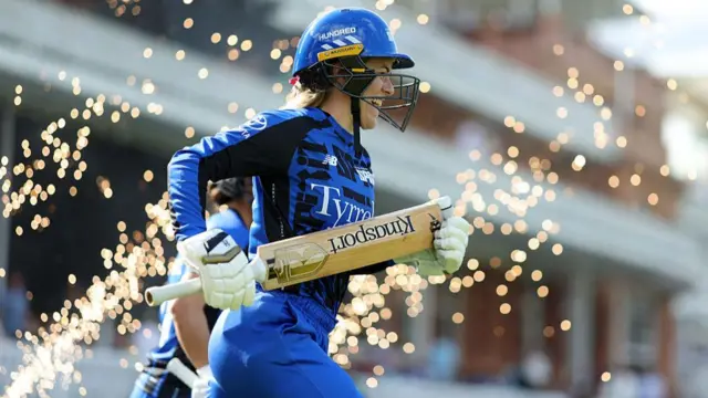 Georgia Redmayne runs through the fireworks to bat vs Trent Rockets.