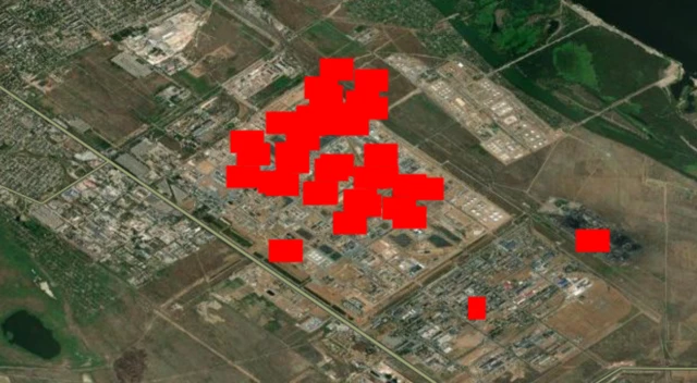 A satellite map with red triangles showing heat sources at the oil refinery