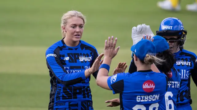 Sarah Glenn of London Spirit celebrates with her team mates after taking the wicket of Ash Gardner