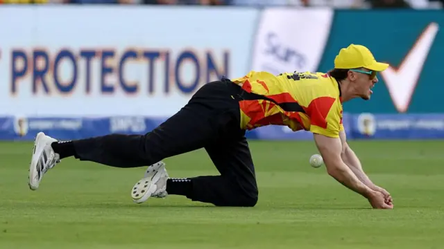 Adam Hose falling to the floor while dropping the ball.