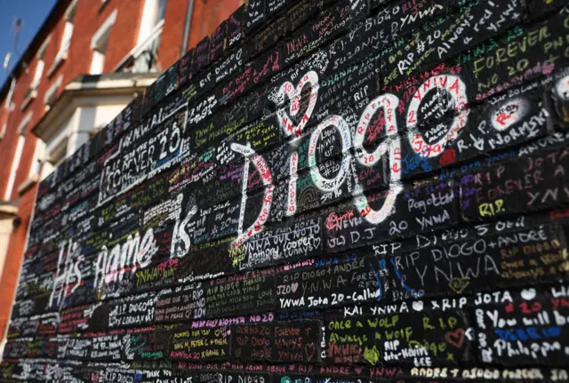 A wall of condolences next to the Diogo Jota mural at Anfield